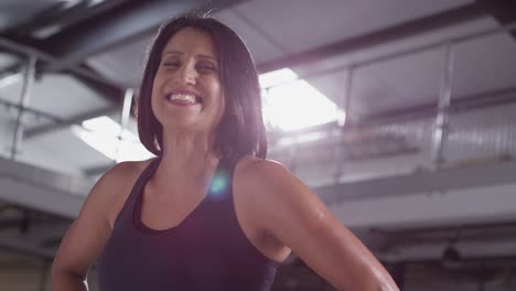 Portrait-Of-Smiling-Mature-Woman-Wearing-Fitness-Clothing-Standing-In-Gym-Ready-To-Exercise